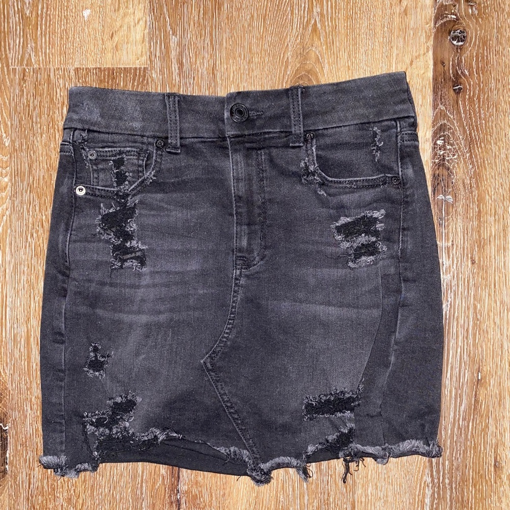 Black denim distressed mini skirt, size 4.
